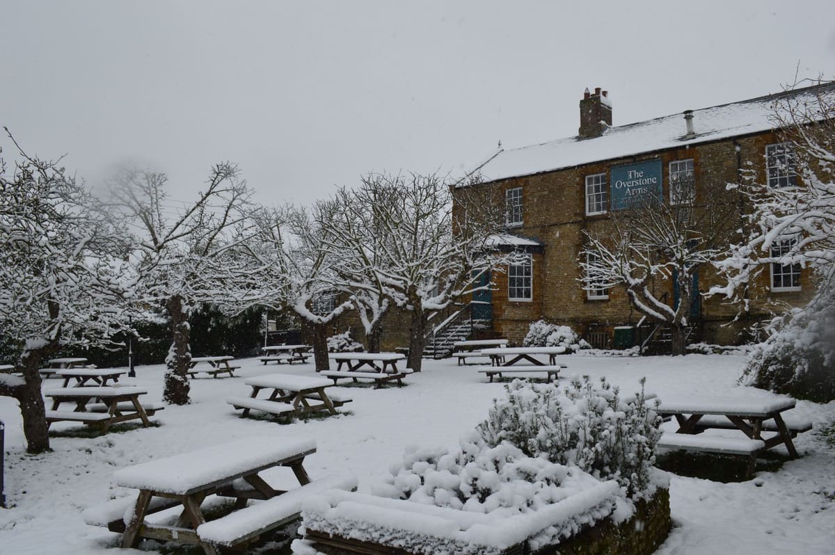 The Overstone Arms under snow at Christmas