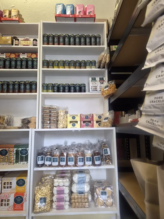 Jars of chutney and shelves of biscuits in the village shop