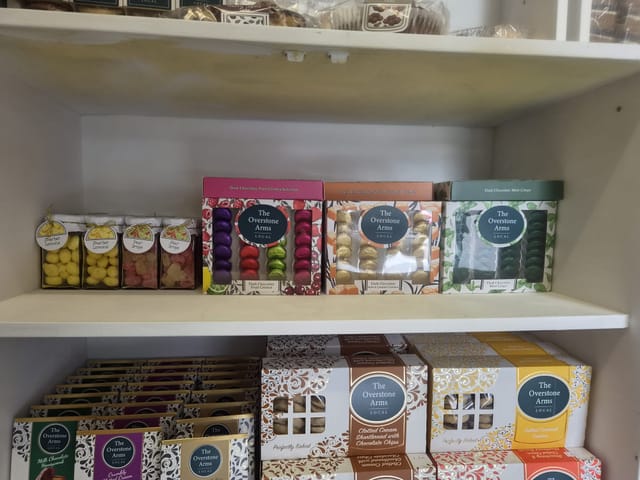 Boxed chocolates, shortbread and sweet jars on the gift shelf