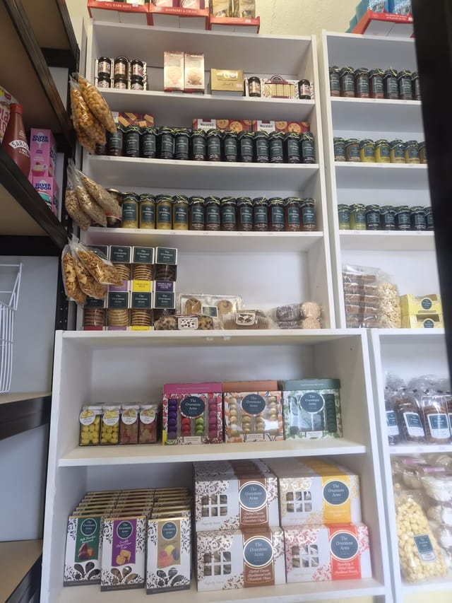 Shelves of chutneys, mustards, sauces and biscuits