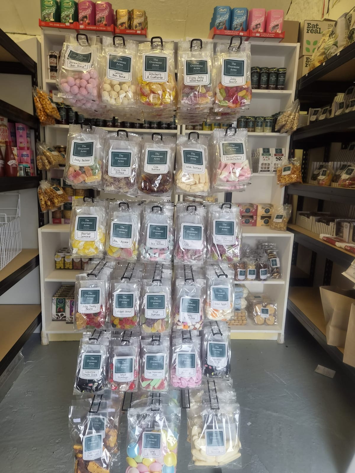 A stand of traditional sweets in bags at The Overstone Arms village shop